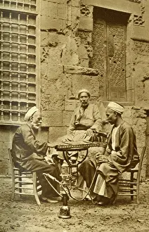 Hookah: Men playing game of draughts in a courtyard, Egypt