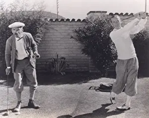Astounded: Men playing golf in backyard