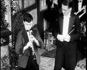 Oboe: Men Playing the Oboe and Conducting