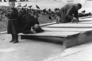 Ulaanbaatar: Men on prayer boards, Gandan Monastery, Mongolia