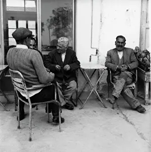 Artichokes: Four men relaxing outside a cafe
