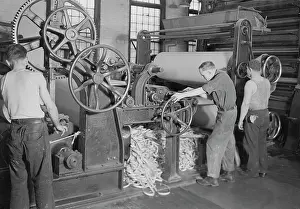 Reel: Men rewinding paper from reel at the American