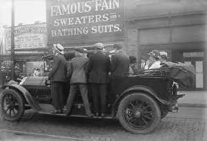 Overloaded: Men ride on the running boards of a improvised ?