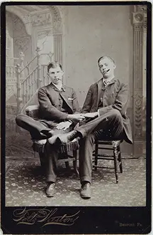 Homosexual: Two men seated on two chairs studio