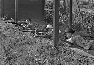 Tripods: Three men at a shooting range