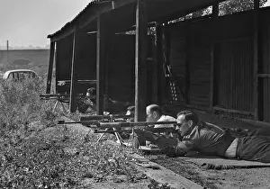Tripods: Three men at a shooting range