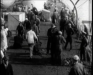 Shovelling: Men Shovelling Coal on the Deck of a Large