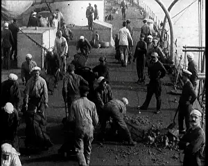 Shovelling: Men Shovelling Coal on the Deck of a Large