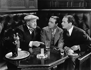 50 60: Three men sitting together at a bar
