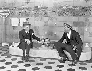 Scrubbing: Two men sitting at the edge of a bathtub in suits