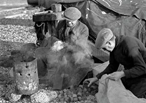 Brazier: Two men sitting by a smoking brazier