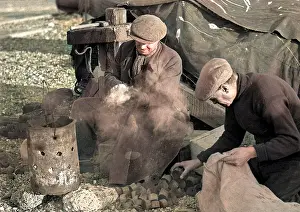 Brazier: Two men sitting by a smoking brazier
