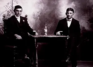 Portait: Two Men Sitting at Table Drinking Beer