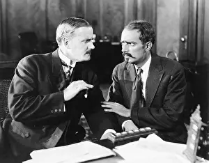 Cautious: Two men sitting together talking