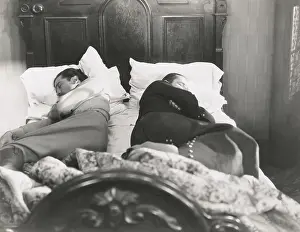 Pillows: Two men sleeping with their backs to each other