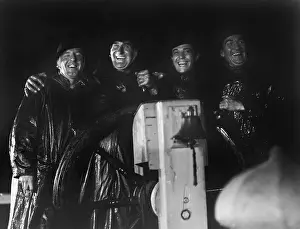 Slickers: Four men in slickers standing together at the captain's