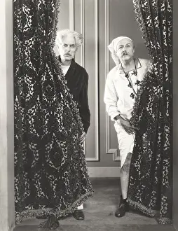 Drapes: Two men spying from behind drapes