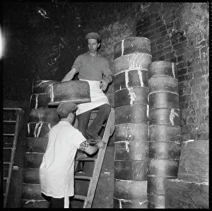 Stacking: Two men stacking saggars containing ceramics