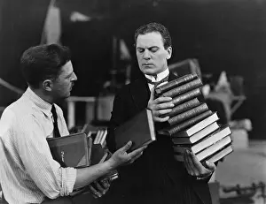 Interactions: Men with stacks of books