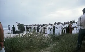 Salalah: Men stand praying by the beach in Oman