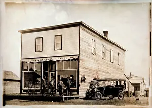 Storefront: Four men standing outside a hardware store