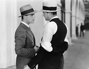 Confronting: Two men standing together talking