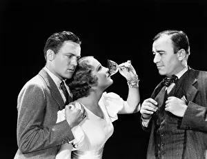 Supportive: Two men supporting a woman drinking