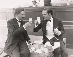 Unison: Two men toasting with milk bottles