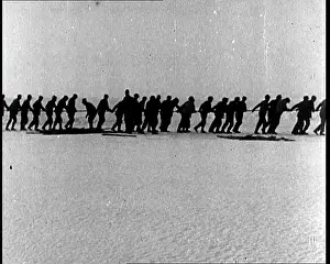 Tugging: Men Tugging A Rope Over An Antarctic Ice Sheet