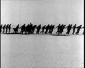 Tugging: Men Tugging A Rope Over An Antarctic Ice Sheet
