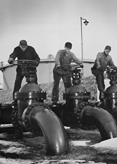 Regulate: Men turn the wheels of large valves that ?