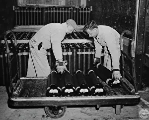 Unloading: Men unloading 105mm artillery shells from a truck, 1943