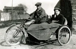Tonneau: Two men on veteran motorcycle & sidecar