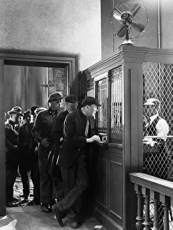Intent: Men waiting in line to place bets