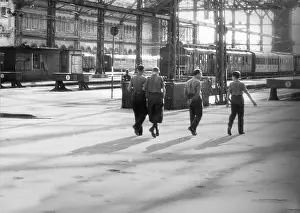 Platforms: Men on the way to the platforms in the main station in M