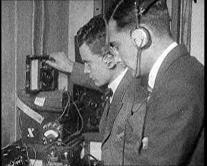 Calibrating: Two Men Wearing Headphones and Calibrating