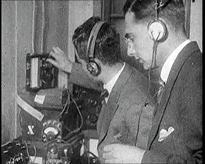 Calibrating: Two Men Wearing Headphones and Calibrating