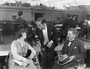 Gentlemanly: Two men and a woman in a restaurant on the pier