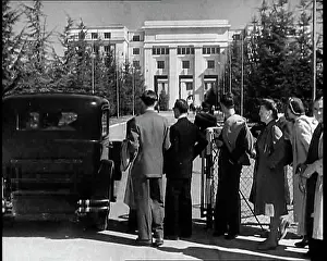 Queueing: Men and Women Queueing By a Security Gate With