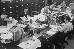 Notebooks: Six men and two women at work in a U.S. government
