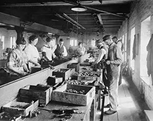 D.c. Vicinity: Men and Women working on an assembly line in the