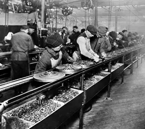 Flywheel: Men work on the flywheel magneto, the first ?