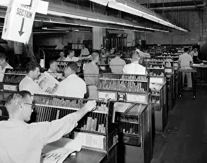 Newsprint: Men working in newspaper advertisement composing