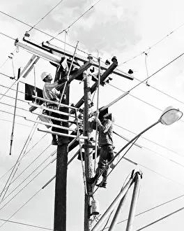 Lineman: Two Men Working on Public Utility Electrical Wires