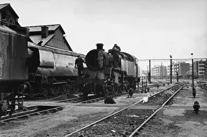 Elms: Men working on steam engine at Nine Elms Loco Yard