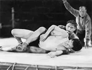 Workouts: Two men wrestling with a referee in the background