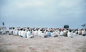 Easterni: Men and young boys sitting on the beach in Oman