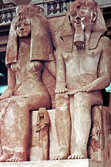 Authors: Menkaura flanked by the goddess Hathor (left)