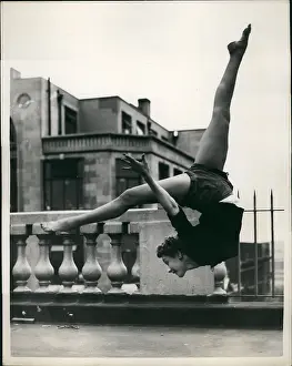 Somersault: Meribeth Old, acrobatic dancer, rehearsing on roof, London