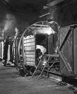Heinz Zinram: Metalworkers welding a railway carriage